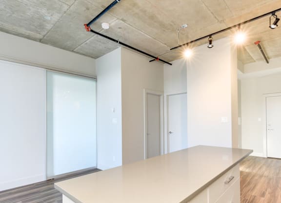 A kitchen with a large island and white cabinets.