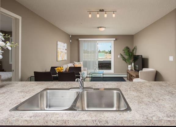A kitchen with a sink and a window.