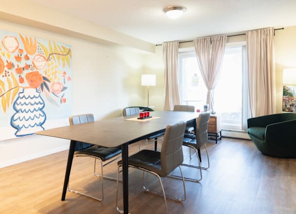 A dining room with a table and chairs.