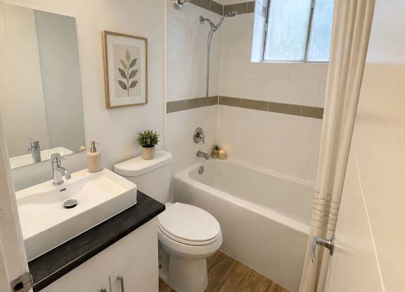 A bathroom with a white toilet, sink, and bathtub.