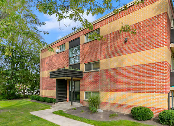 A red brick building with a black door and windows.