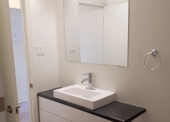 A bathroom with a sink and mirror.
