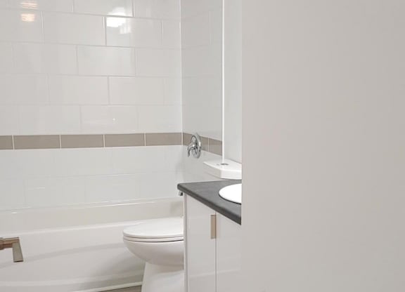 A white toilet sits next to a sink in a bathroom.