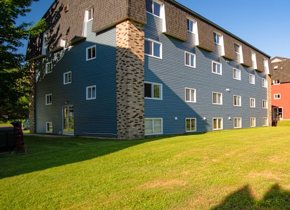 A large building with a mix of blue and grey siding.