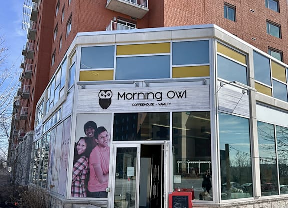 A building with a sign that says "Morning Owl" on it.