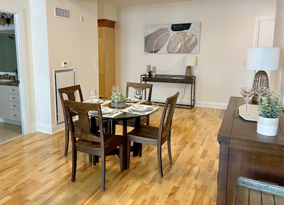 A dining room with a wooden table and chairs.