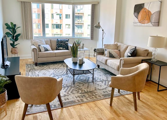 A living room with two couches, a coffee table, and a chair.