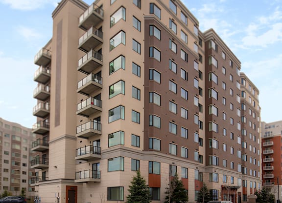 A large apartment building with balconies on the second floor.