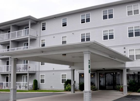 A large building with a covered walkway in front.