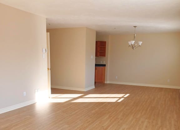 A room with wooden floors and a chandelier.
