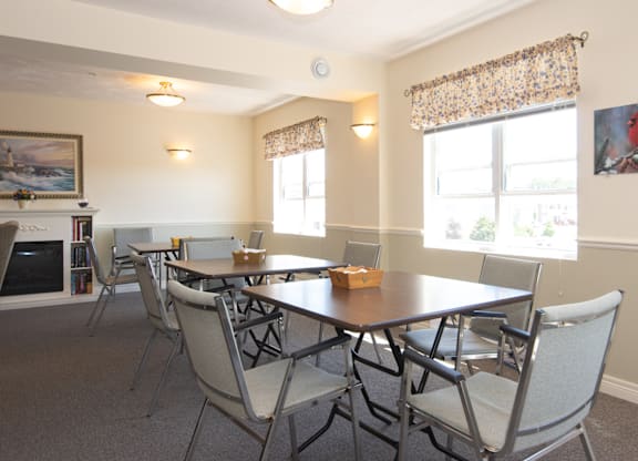 A dining room with a table and chairs.