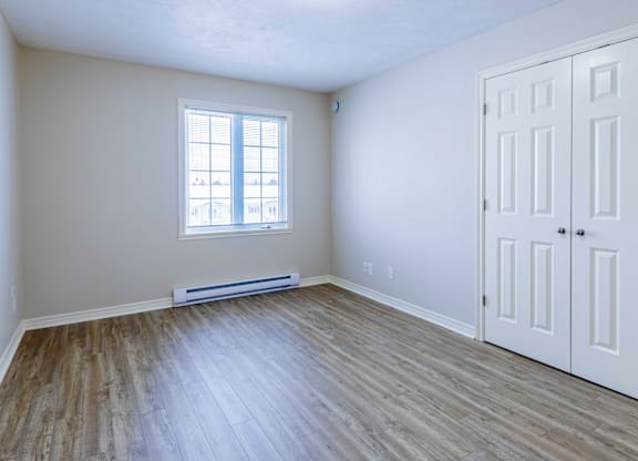 A room with a window and a door.