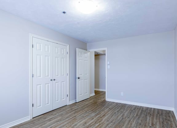 A room with two doors and a wooden floor.