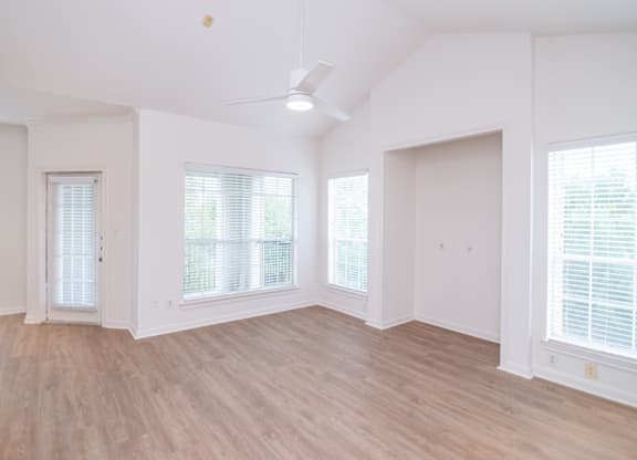 Living room with a ceiling fan and windows with blinds at Whitney at the Heights, Houston, TX, Texas, 77008