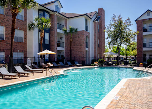 Swimming Pool With Lounge Chairs at Whitney at the Heights, Texas