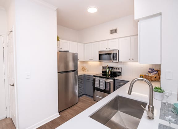 Kitchen with a stainless steel refrigerator and a sink at Whitney at the Heights, Houston, TX, Texas