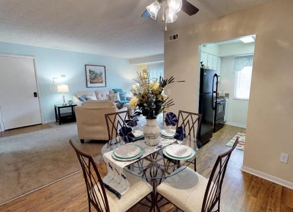 an open living room and dining room with a table and chairs  at Hunter's Creek Apartments, Ohio
