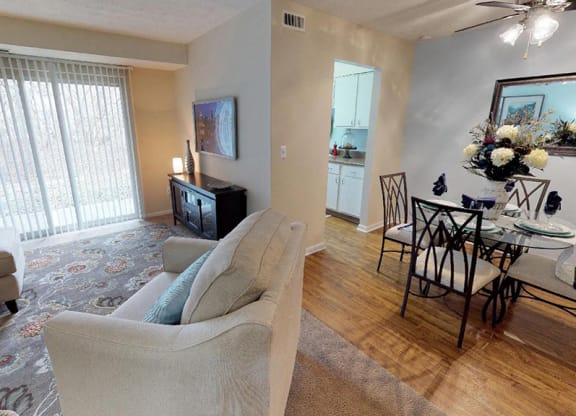 a living room and dining room with a table and chairs  at Hunter's Creek Apartments, Cincinnati, OH
