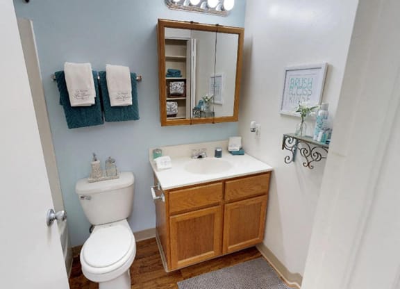 a bathroom with a sink toilet and a mirror  at Hunter's Creek Apartments, Cincinnati, 45242