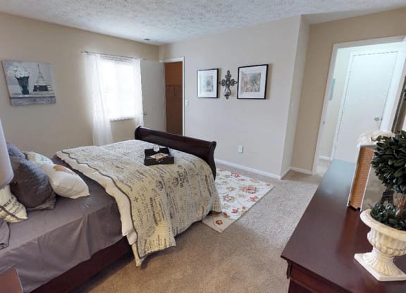 a bedroom with a bed and a dresser in it  at Hunter's Creek Apartments, Cincinnati, OH, 45242