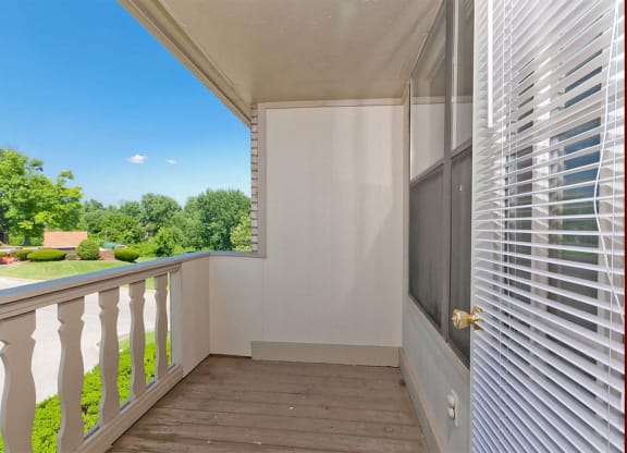 a balcony with a view of a yard and a door to a balcony  at Four Worlds Apartments, Cincinnati, OH, 45231
