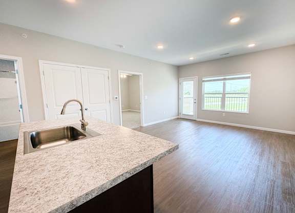 A kitchen with a sink and a window.