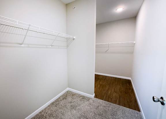 Empty room with white walls and a carpeted floor.