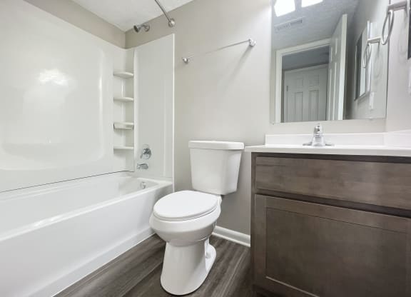 a bathroom with a toilet and a tub and a sink at Revere Village Apartments, Ohio, 45458