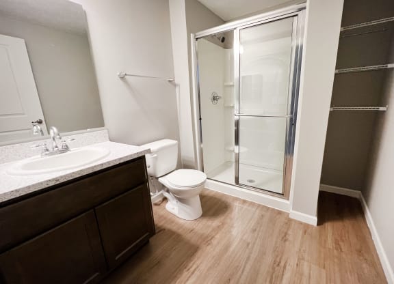 an empty bathroom with a shower toilet and sink  at Brookfield Village Apartments, Ohio, 43123