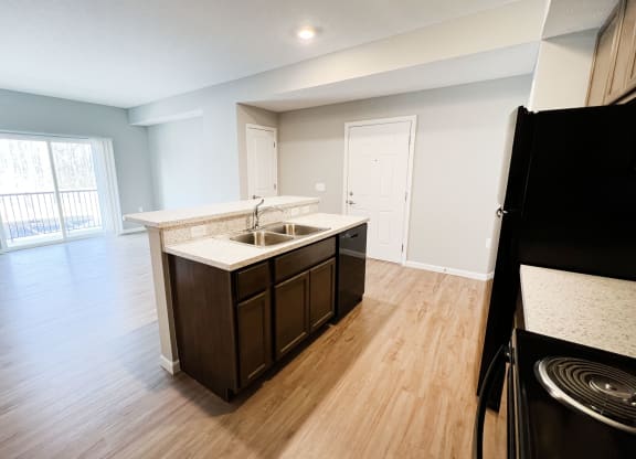 an empty kitchen and living room with wood flooring and a window  at Brookfield Village Apartments, Ohio, 43123