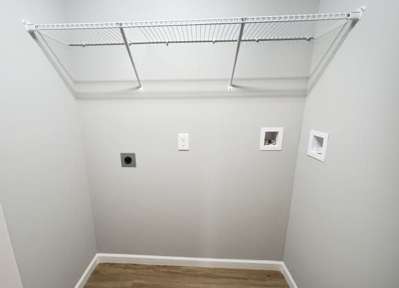 a room with white walls and a ceiling with pictures on it  at Brookfield Village Apartments, Grove City