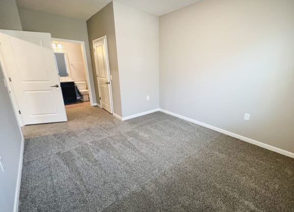 an empty living room with carpeting and white walls  at Brookfield Village Apartments, Ohio