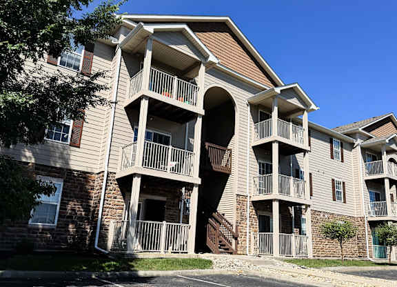 A large apartment building with a balcony on the second floor.