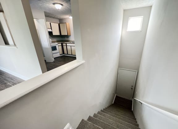 a stairwell in a home with white walls and a kitchen at 450 on Keeneland Apartments, Richmond, 40475