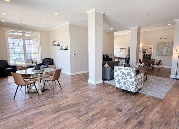 A living room with a dining table and chairs.