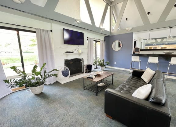 a living room with a black leather couch and a television at Miamisburg by the Mall, Miamisburg, OH, 45342