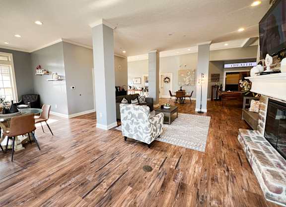 the view of a living room with a fireplace and wooden floors at The Residences at Liberty Crossing, Columbus
