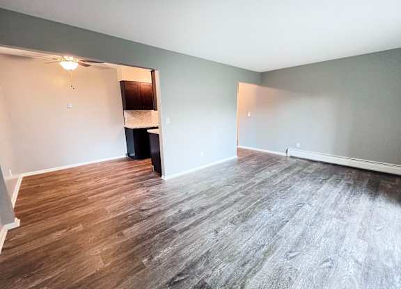 A room with wooden flooring and a white ceiling.