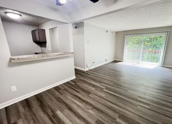 an empty living room with hardwood flooring and a window at Fox Run Apartments, Cincinnati
