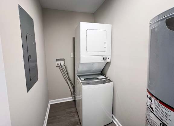 A white washing machine in a small laundry room.