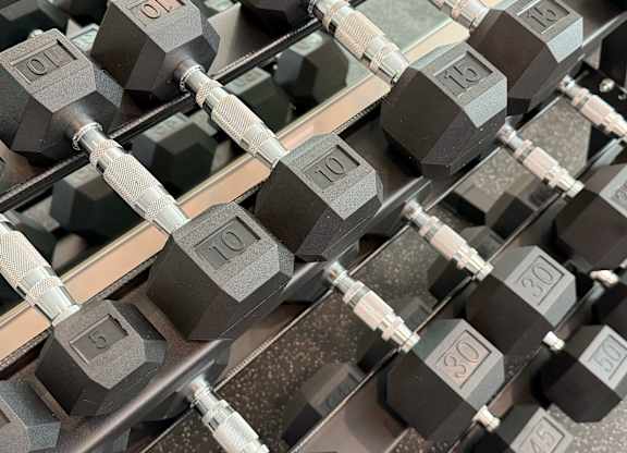 A set of black dumbbells with weights ranging from 5 to 30.