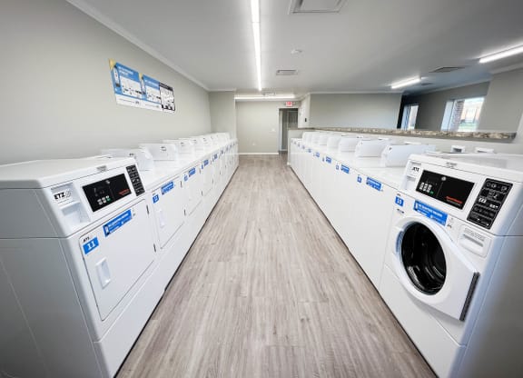 a washer and dryer laundry room with rows of washes and dryers  at Forest Park Apartments, Forest Park, Ohio