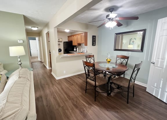a living room and dining room with a couch and a table at Fox Run Apartments, Cincinnati