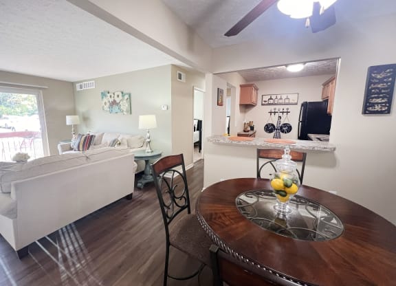 a living room and dining room with a table and a couch at Fox Run Apartments, Cincinnati