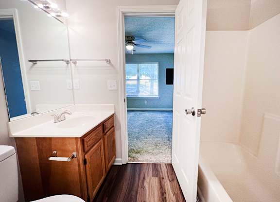 A bathroom with a white sink and a white toilet.