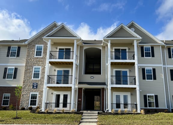 a large apartment building with stairs in front of it