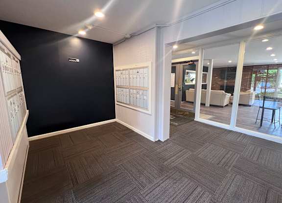 A room with a black wall and a wooden floor.