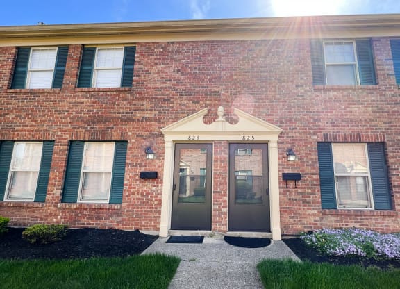 the front of a brick building with two doorsat Revere Village Apartments, Ohio, 45458
