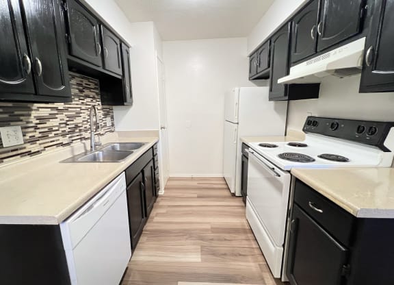 an empty kitchen with white appliances and black and white cabinets at Hunter Ridge Apartments, Cincinnati, 45244