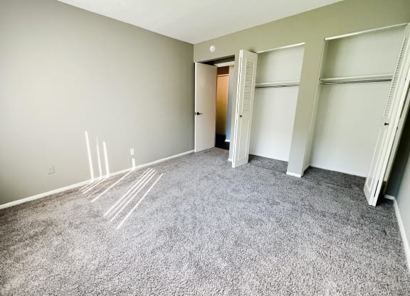 an empty room with a carpeted floor and three closets at Crown Pointe Apartments, Kentucky, 41014